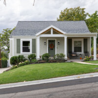 Thumbnail of http://Front%20exterior%20of%20cottage%20style%20home.%20The%20yard%20is%20landscaped%20with%20grass%20and%20includes%20a%20path%20with%20access%20to%20the%20front%20porch.