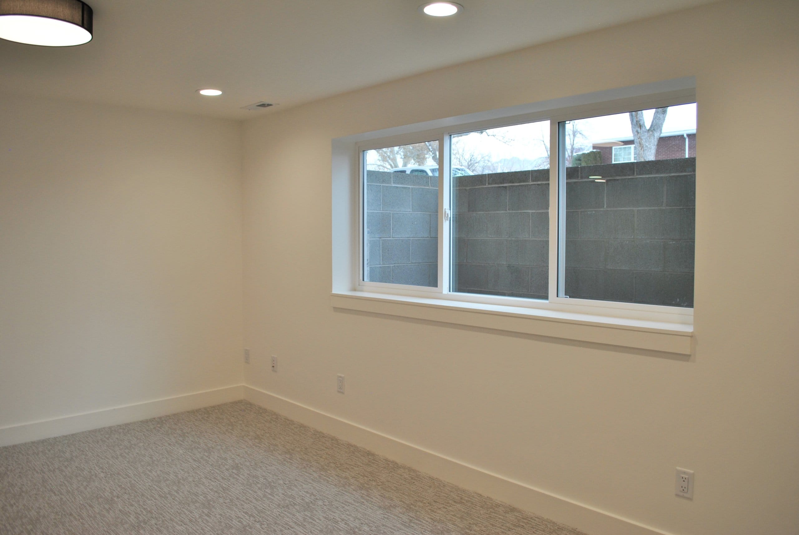 Lower level room with large windows.