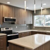 Thumbnail of http://Kitchen%20with%20an%20island,%20dark%20cabinetry,%20and%20a%20large%20window%20above%20the%20sink.