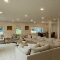 Thumbnail of http://Large,%20open%20concept%20great%20room%20looking%20from%20the%20family%20room%20to%20the%20dining%20room.%20The%20family%20room%20includes%20a%20large%20L-shaped%20couch,%20two%20chairs%20with%20a%20side%20table%20between,%20and%20a%20coffee%20table.