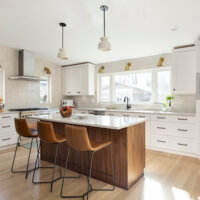 Thumbnail of http://Kitchen%20addition%20that%20features%20a%20large%20island%20with%20seating%20for%20three%20in%20the%20center%20and%20a%20large%20window%20centered%20above%20the%20sink