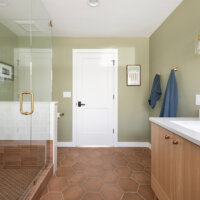 Thumbnail of http://Primary%20bathroom%20with%20shower%20on%20the%20left%20side,%20entrance%20straight%20ahead,%20and%20sink%20on%20the%20right%20side.%20The%20room%20features%20green%20walls,%20hexagon%20tiles%20on%20the%20floor,%20and%20gold%20fixtures.