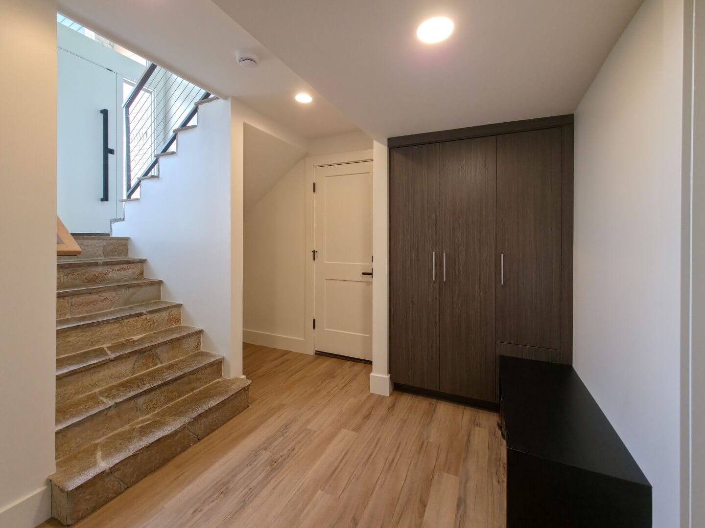 Basement mudroom design with built-in cabinets.