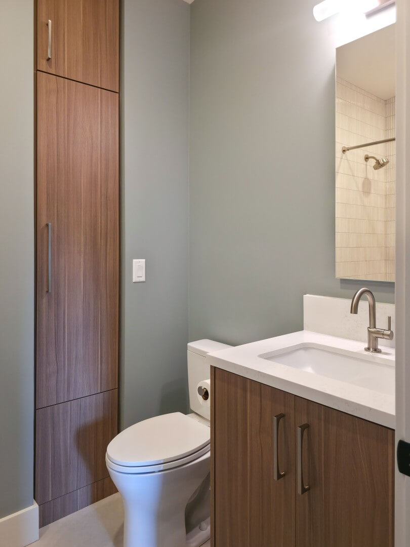 Custom bathroom renovation with the sink, toilet, and a built-in.