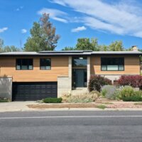 Thumbnail of http://Front%20exterior%20of%20a%20split%20level%20home%20after%20the%20renovation.%20The%20design%20includes%20a%20mix%20of%20siding%20and%20brick%20with%20the%20front%20door%20in%20the%20center,%20and%20a%20garage%20on%20the%20left.