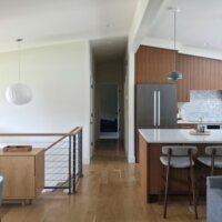 Thumbnail of http://Open%20concept%20mid-century%20modern%20design%20following%20the%20renovation.%20On%20the%20left%20are%20the%20stairs%20to%20the%20front%20door%20and%20basement.%20On%20the%20right%20is%20the%20kitchen.
