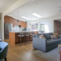 Thumbnail of http://Open%20concept%20living%20room,%20dining%20room,%20and%20kitchen%20after%20the%20renovation.%20The%20space%20features%20vaulted%20ceilings%20and%20lots%20of%20natural%20light.