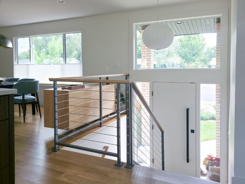 Split level home staircase down to the front door.