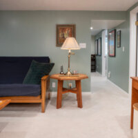 Thumbnail of http://Basement%20family%20room%20looking%20at%20a%20couch,%20side%20table,%20and%20hallway.