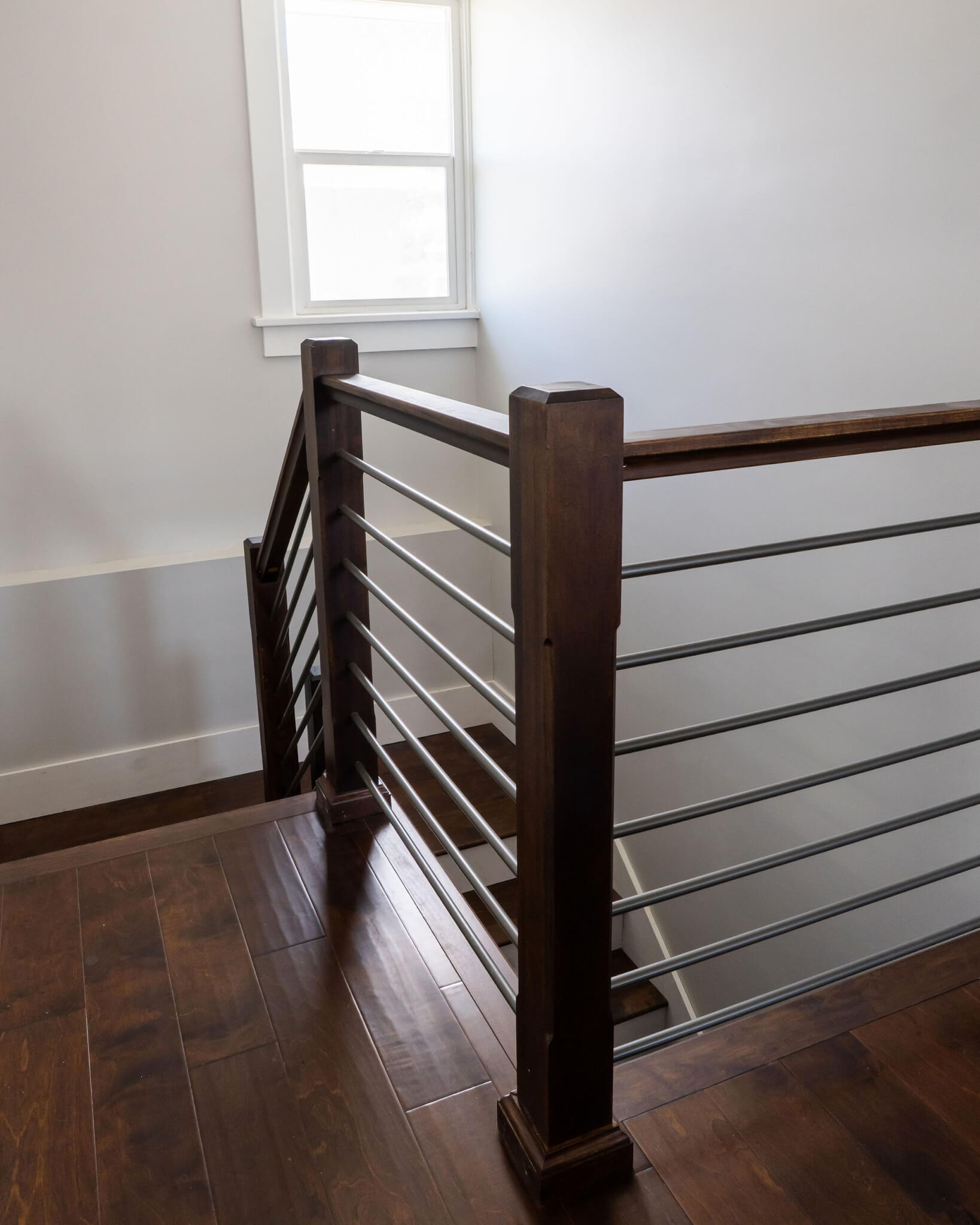 Modern railing around the staircase to the basement.