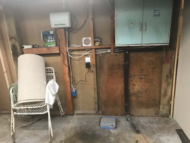 Unfished basement with two chairs to the side.