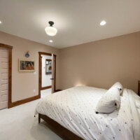 Thumbnail of http://Large%20basement%20bedroom%20with%20bed,%20door%20with%20access%20to%20the%20hallway,%20and%20a%20pocket%20door%20with%20access%20to%20the%20bathroom.