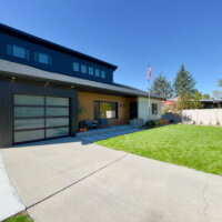 Thumbnail of http://Exterior%20of%20house%20remodel%20with%20a%20covered%20front%20porch,%20green%20lawn,%20and%20driveway%20with%20access%20to%20the%20one%20car%20garage.