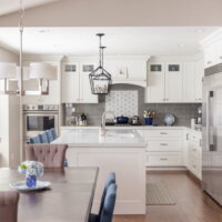 Thumbnail of http://Modern%20Country%20kitchen%20renovation.%20The%20kitchen%20features%20a%20large%20fridge%20and%20freezer,%20island%20with%20seating%20and%20a%20sink,%20double%20ovens,%20gray%20tile%20backsplash,%20built-in%20bench%20seat,%20and%20open%20concept%20layout%20with%20the%20dining%20room.
