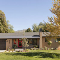 Thumbnail of http://Exterior%20of%20home%20after%20the%20remodel%20featuring%20painted%20brick,%20a%20covered%20front%20porch,%20and%20updated%20landscaping.