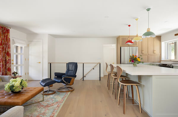 Open concept kitchen and living room. On the left is the living room and on the right is the kitchen. Straight ahead are the stairs to the basement.