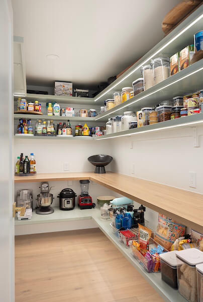 Large walk-in pantry with open shelves.