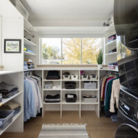 Thumbnail of http://Primary%20closet%20with%20lots%20of%20storage%20and%20a%20stacked%20washer%20and%20dryer.