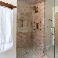 Thumbnail of http://Primary%20bathroom%20shower%20with%20a%20glass%20door.