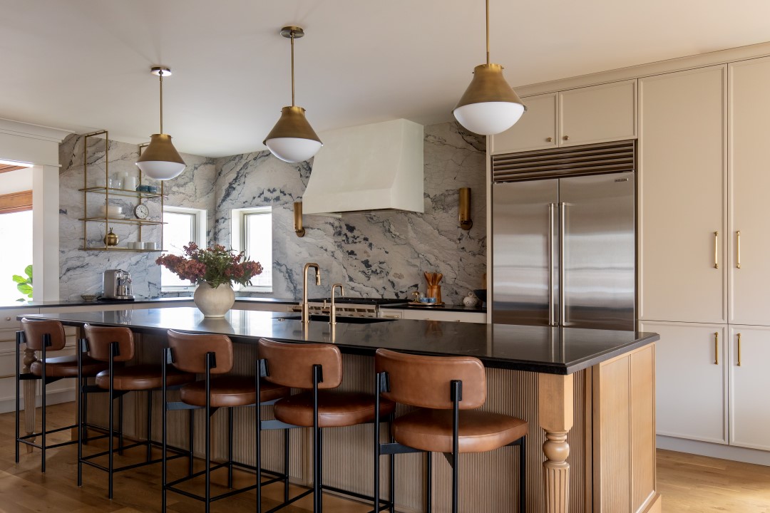 Modern kitchen in a historic home that blends the old with the new. Features updated finishes, a large island with seating, and cabinetry with storage and prep space