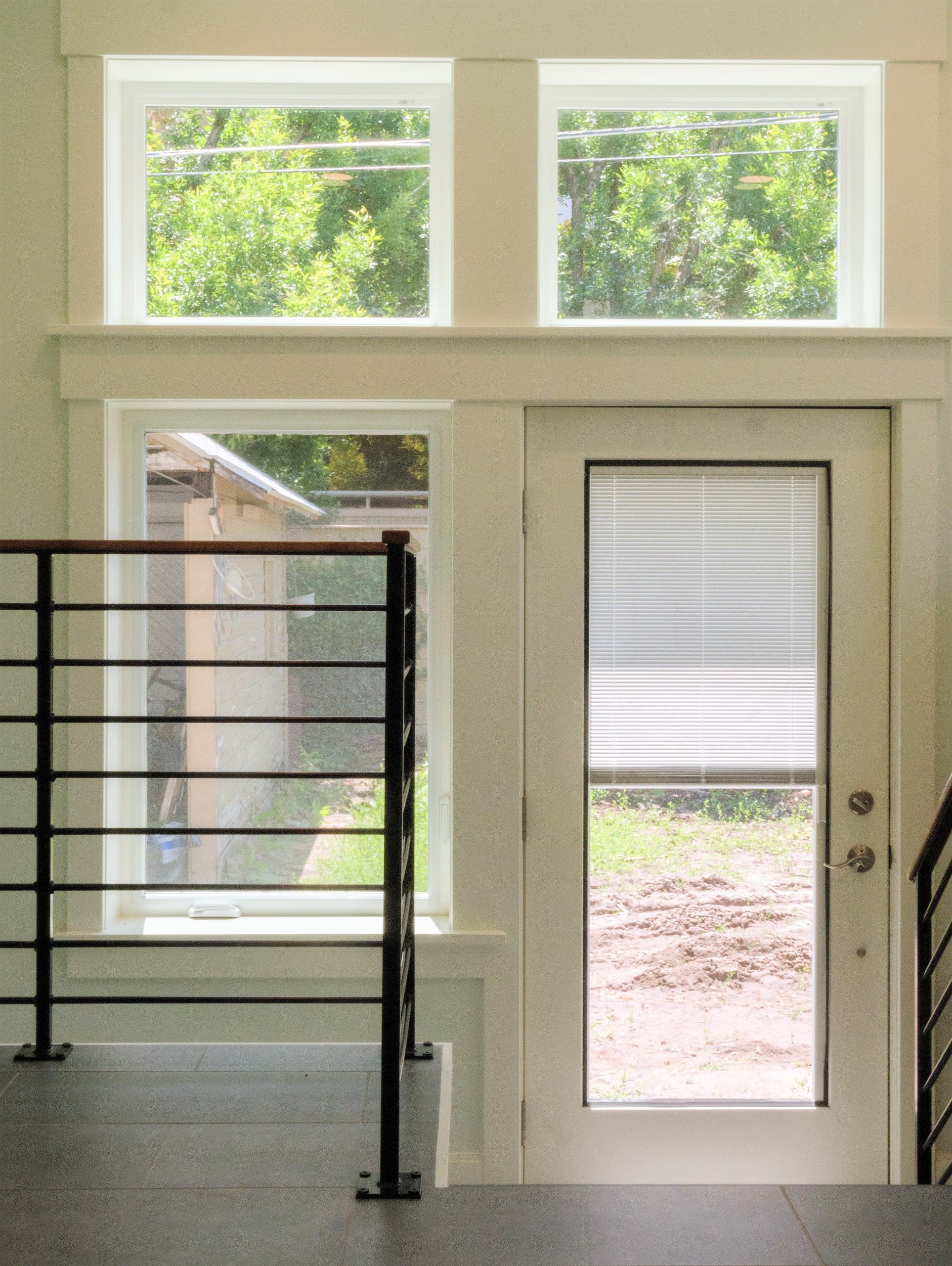 Staircase leading to the back door with windows.