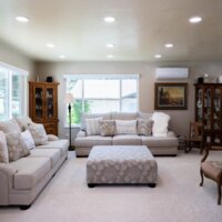 Thumbnail of http://Family%20room%20remodel%20with%20the%20two%20couches%20under%20the%20windows,%20bookcases,%20and%20chairs%20around%20the%20ottoman%20in%20the%20center.