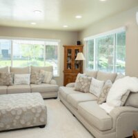 Thumbnail of http://Family%20room%20remodel%20with%20the%20two%20couches%20under%20the%20windows%20and%20a%20bookcase%20in%20the%20corner%20between.