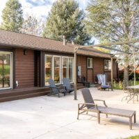 Thumbnail of http://Backyard%20patio%20with%20outdoor%20furniture%20and%20a%20pergola%20structure.