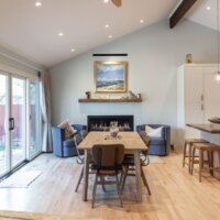 Thumbnail of http://Renovated%20open%20concept%20great%20room%20with%20vaulted%20ceilings.%20The%20dining%20table%20sits%20in%20front%20of%20the%20modern%20fireplace%20and%20has%20a%20table%20with%20seating%20for%20six.%20On%20the%20left%20are%20glass%20sliding%20doors%20to%20the%20patio.%20On%20the%20right%20is%20a%20small%20view%20to%20the%20updated%20kitchen.