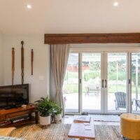 Thumbnail of http://Family%20room%20with%20sliding%20doors%20to%20the%20patio,%20tall%20ceilings,%20and%20furniture.