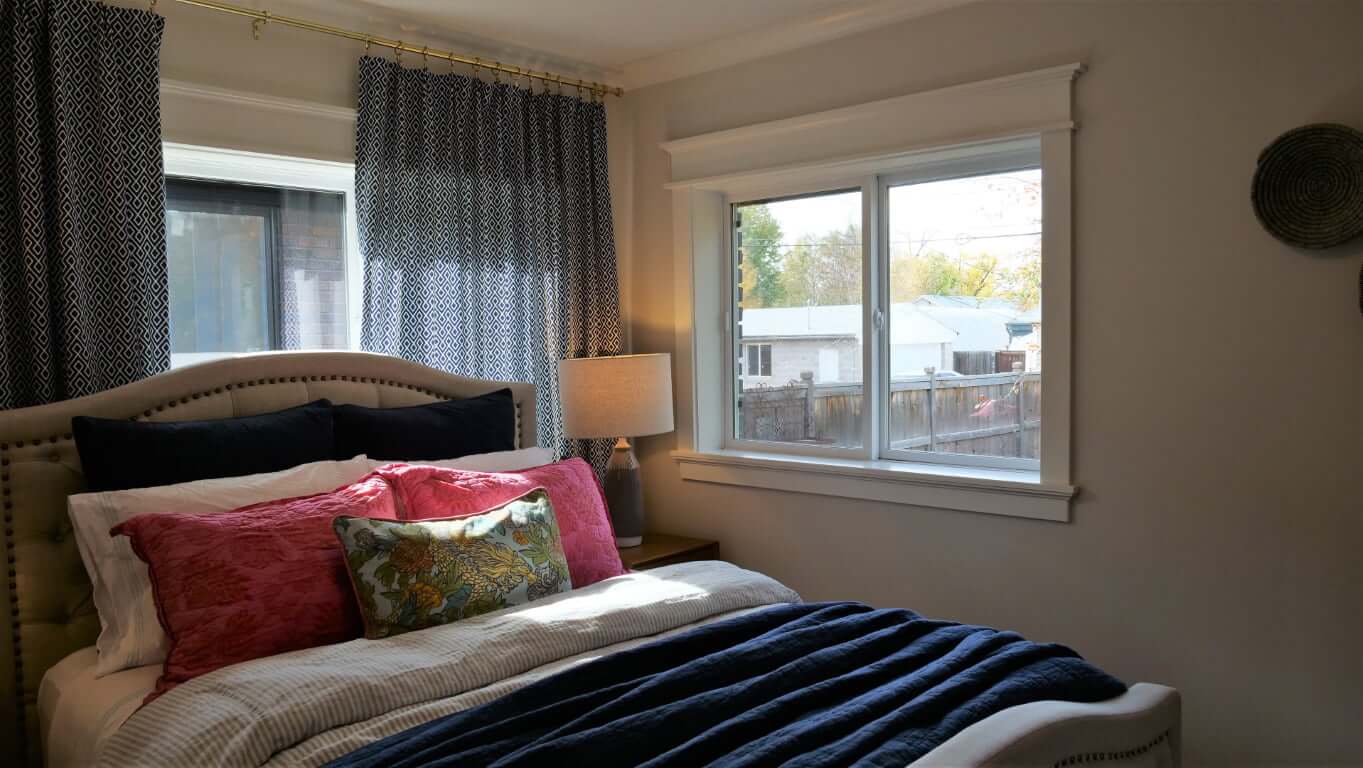 Primary bedroom with a large bed, windows, and nightstands.