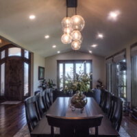 Thumbnail of http://Dining%20room%20at%20a%20mountain%20home%20with%20a%20view%20of%20the%20front%20door%20and%20seating%20for%20eight%20around%20the%20table.
