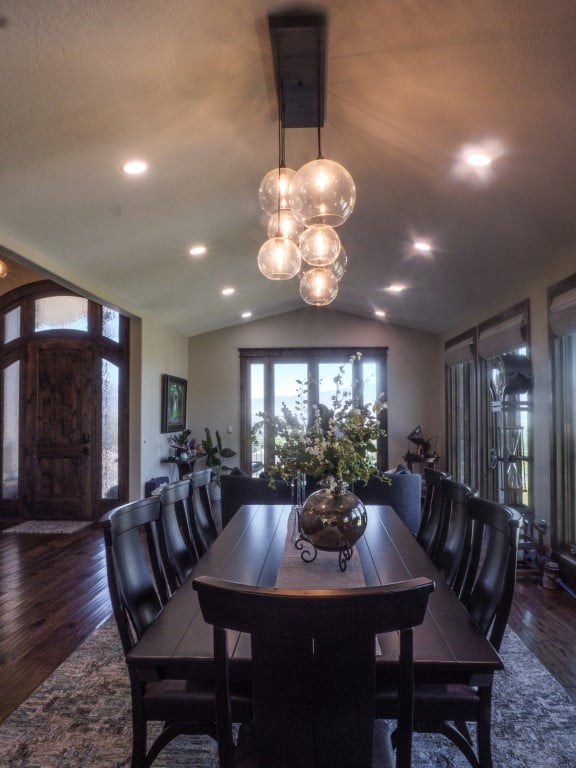 Dining room at a mountain home with a view of the front door and seating for eight around the table.