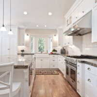 Thumbnail of http://Large%20Kitchen%20with%20white%20cabinets%20and%20hardwood%20floors%20and%20farm%20sink%20|%20Renovation%20Design%20Group