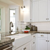 Thumbnail of http://White%20farm%20sink%20and%20white%20cabinets%20in%20kitchen%20|%20Renovation%20Design%20Group