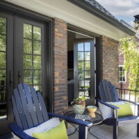 Thumbnail of http://Front%20porch%20with%20french%20doors%20to%20the%20living%20room.%20On%20the%20front%20porch%20are%20two%20adirondack%20chairs%20and%20a%20round%20table%20between.