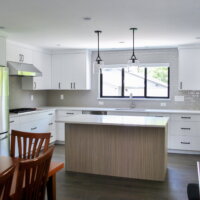 Thumbnail of http://Open%20concept%20kitchen%20and%20dining%20room%20after%20the%20remodel.%20The%20kitchen%20is%20large%20and%20includes%20double%20ovens,%20an%20island%20with%20room%20for%20seating,%20and%20a%20sink%20under%20the%20window.