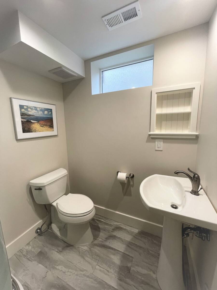 Small basement bathroom with a sink and toilet.