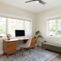Thumbnail of http://Home%20office%20furnished%20with%20a%20desk,%20plants,%20and%20bench%20seat.