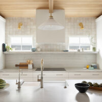 Thumbnail of http://New%20kitchen%20design%20with%20white%20cabinetry,%20gold%20fixtures,%20and%20wood%20on%20the%20partially%20vaulted%20ceiling.