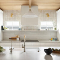 Thumbnail of http://New%20kitchen%20design%20with%20white%20cabinetry,%20gold%20fixtures,%20and%20wood%20on%20the%20partially%20vaulted%20ceiling.