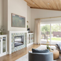 Thumbnail of http://Living%20room%20with%20a%20vaulted%20ceiling,%20fireplace%20framed%20by%20bookcases,%20and%20an%20open%20concept%20layout%20to%20the%20kitchen%20and%20dining%20room.