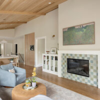Thumbnail of http://Living%20room%20with%20a%20vaulted%20ceiling,%20fireplace%20framed%20by%20bookcases,%20and%20an%20open%20concept%20layout%20to%20the%20kitchen%20and%20dining%20room.