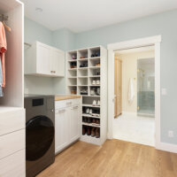 Thumbnail of http://Large%20walk-through%20primary%20closet.%20The%20closet%20features%20a%20combined%20washer%20and%20dryer,%20shoe%20storage,%20and%20plenty%20of%20hanging%20space%20for%20clothes.%20Straight%20ahead%20is%20the%20opening%20into%20the%20primary%20bathroom.
