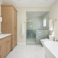 Thumbnail of http://Primary%20bathroom%20with%20the%20sink%20and%20cabinetry%20on%20the%20left,%20shower%20straight%20ahead,%20and%20the%20toilet%20and%20tub%20on%20the%20right.