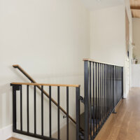 Thumbnail of http://Custom%20built-in%20dog%20gate%20at%20the%20top%20of%20the%20stairs%20that%20matches%20with%20the%20railing.