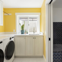 Thumbnail of http://Laundry%20room%20in%20the%20basement%20with%20a%20window%20above%20the%20sink%20and%20yellow%20paint%20on%20the%20walls.