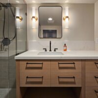 Thumbnail of http://Modern%20bathroom%20vanity%20with%20storage,%20lighting,%20and%20a%20mirror%20centered%20above%20the%20sink.